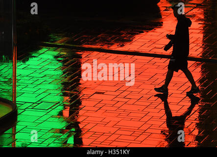 Peking, China. 4. Oktober 2016. Die Menschen gehen über Sanlitun Geschäftsstraße nach einem Niederschlag in Peking, Hauptstadt von China, 4. Oktober 2016. © Li He/Xinhua/Alamy Live-Nachrichten Stockfoto