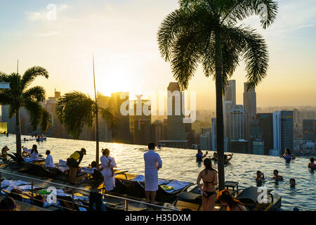 Infinity-Pool auf dem Dach des das Marina Bay Sands Hotel mit spektakulärem Blick über die Skyline von Singapur bei Sonnenuntergang, Singapur Stockfoto