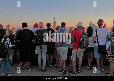 Touristen auf "Top of the Rock" mit Blick auf das Empire State Building in Manhattan, New York City, New York, Vereinigte Staaten. Stockfoto