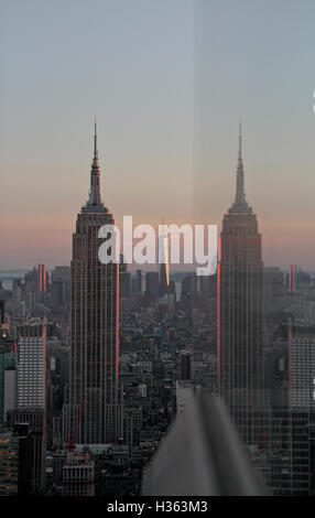 Das Empire State Building und ihre Reflexion in eine Glasscheibe, Manhattan, New York City, New York, Vereinigte Staaten von Amerika. Stockfoto