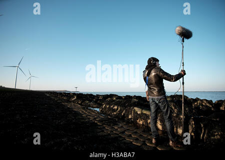 Sound-Künstler Justin Bennett Aufzeichnung Geräusche im und um den Container-Häfen und Windkraftanlagen um Euromax Terminal Stockfoto