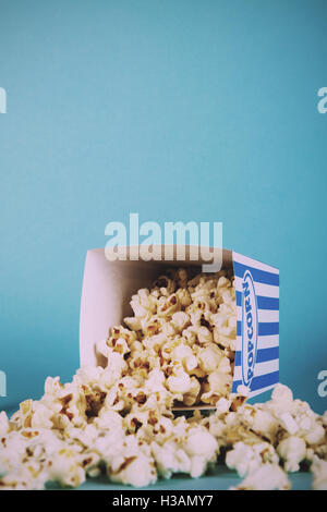 Eimer Popcorn vor einem blauen Hintergrund Vintage Retro-Filter.