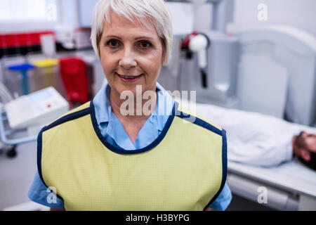 Porträt von lächelnden Arzt stehen im Röntgenraum Stockfoto