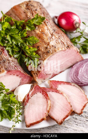 Geräuchert und würzigen Schweinelende mit Zwiebeln Scheiben Stockfoto