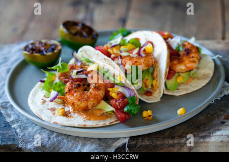 Garnelen-Tacos mit Avocado, Salat, Mais und Tomaten-salsa Stockfoto