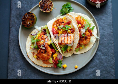 Garnelen-Tacos mit Avocado, Salat, Mais und Tomaten-salsa Stockfoto