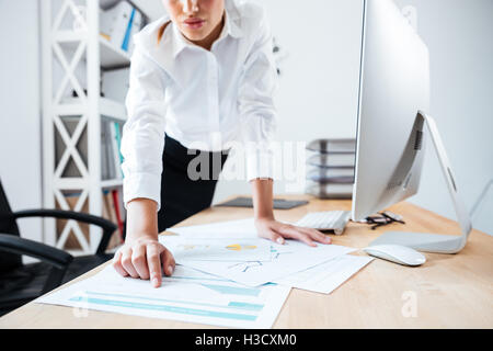 Bild von smart schweren Geschäftsfrau Zeigefinger auf Arbeitsunterlagen auf dem Tisch im Büro beschnitten Stockfoto