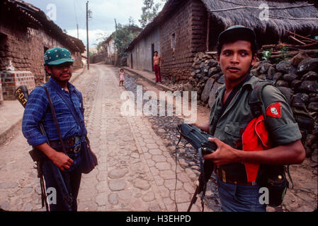 TENANCINGO, EL SALVADOR, März 1984: - im Rahmen der FPL-Guerilla Zonen des Steuerelements.  Zwei Guerilla-Kämpfer machen ihren Weg durch die verlassenen Straßen der umkämpften Stadt. Stockfoto