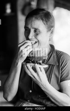 CHALATENANGO, EL SALVADOR, FEB 1984: - innerhalb der FPL Guerilla Zonen der Steuerung Porträt einer Frau, Tortilla und Bohnen essen.   Foto: Mike Goldwater Stockfoto