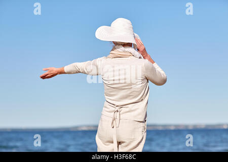 glücklich senior Frau Sonnenhut Sommer Strand Stockfoto