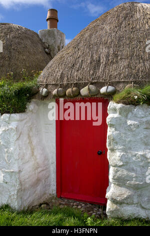 Typisches altes Landhaus mit Steinen auf Stroh, Balevullin Bay, Tiree, Inneren Hebriden, Argyll and Bute, Scotland Stockfoto