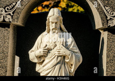 Christus-Statue mit Kopf nach unten auf einem Friedhof Stockfoto