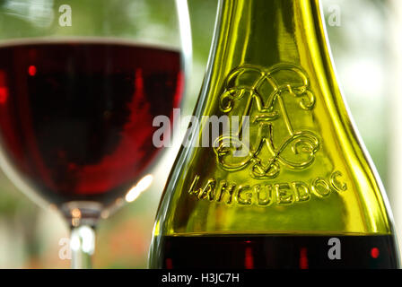 LANGUEDOC ROTWEIN ALFRESCO Flasche und Glas Französisch Languedoc Rotwein auf sonniger Terrasse Stockfoto