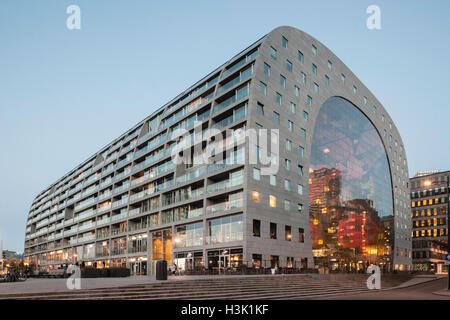 Seitenansicht des geschwungenen Gebäude mit Kontext und Passanten auf dem öffentlichen Platz. Markthalle Rotterdam, Rotterdam, Niederlande. Architekt: MVRDV, 2014. Stockfoto