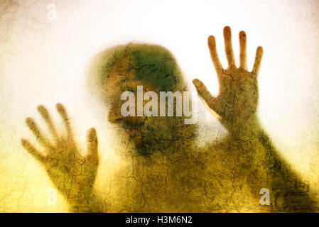 Eingeschlossenen Mann Konzept mit Rückseite beleuchteten Silhouette der Hände hinter Mattglas, nützlich als anschauliches Bild für den Menschenhandel, pr Stockfoto