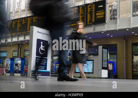 Langsame Verschlusszeit verwendet, um übertriebene Bewegung von Menschen in Kings Cross St Pankreas Station,London,U.K aufzuzeichnen. Stockfoto