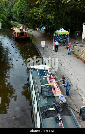 Handbemalte Geschenke werden von einem Schmalschiff in Saltaire am Leeds und Liverpool Kanal verkauft Stockfoto