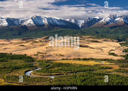 Ansicht von oben Steppe Fluss gelb Steppe mit grünen Wald unter Schnee eis Gebirge und Gletscher auf Hochland Stockfoto