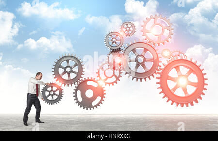 Mann legte abstrakt 3d Metall-Getriebe Stockfoto