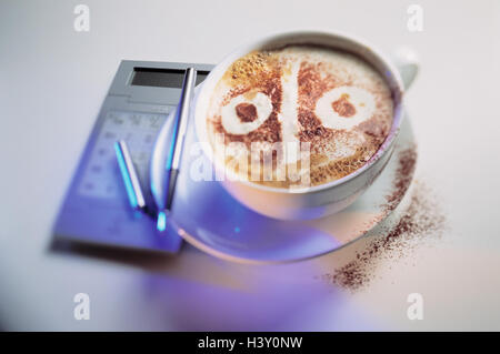 Tasse Cappuccino Brusthaut Schaum, Prozentzeichen, elektronische Rechner, Stillleben, Produkt Fotografie, Kaffee, Getränk, Prozent, Konvertierung, DM, Euro, Unterschiede zwischen Preiserhöhung, Preissenkung, Kaffee, günstiger Preis, Preise, teurer, Studio Stockfoto