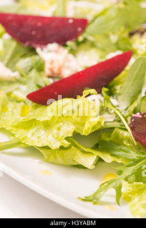 Salat mit Roter Beete in Nahaufnahme. Gesunde Ernährung-Essen mit Gemüse. Serviert auf einem Teller als vegetarisches Gericht oder Vorspeise. Stockfoto