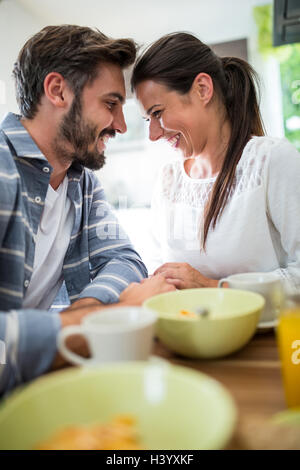 Romantisches Paar auf der Suche von Angesicht zu Angesicht beim Frühstück Stockfoto
