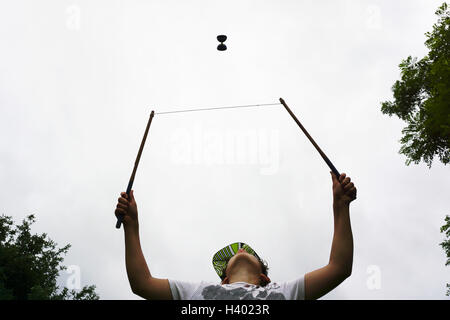 Niedrigen Winkel Ansicht der junge spielt mit Diabolo gegen Himmel Stockfoto