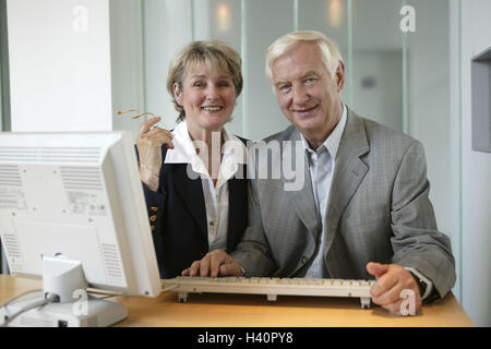 Büro, Arbeitsplatz, älteres Paar, Lächeln, Computer, Porträt, paar, Senioren, 50-60 Jahre, 60-70 Jahre, Büroangestellte, Büroangestellte, Geschäftsfrau, Geschäftsmann, Büro, Geschäft, Display, überwachen, Flatscreen, Sachbearbeiter, Kassierer, Schalter, Berater, Beruf, Arbeit, Finanzen, Finanzberater, Einkaufen, Kollege, offen, weiter Bildung, Ausbildung, EDV-Kurs, zusammen Stockfoto