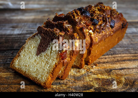 Marmor-lbs-Kuchen mit kandierten Mandeln und Preiselbeeren auf einem Holzbrett Stockfoto