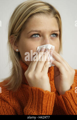 Jugendlicher, Mädchen, Blond, Taschentuch, Schneuzen, Porträt, Seitenansicht, Modell veröffentlicht, Menschen, Frauen Porträt, Frau, jung, Teenager, Schnur Pullover, Walzenzapfen, Roll Sweatshirt mit Knopfleiste, Orange, Krankheit, Kälte, Schnupfen, allgemeine Ansichten, Papiertaschentuch, Studio, Stockfoto