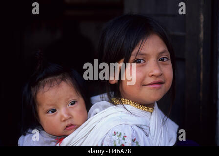 Ecuador, Provinz Imbabura, Kanton Otavalo Markt, Native, Mädchen, Kind, Rücken, Carry, Porträt, kein Model-Release, Südamerika, Menschen, einheimische, Otavalenio, Perle Halskette, schwarz haarig, Lächeln, Schwestern, Geschwister, Kinder, Stockfoto