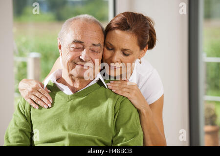 Senior Mann wird von seiner Tochter zu Hause gepflegt, Stockfoto