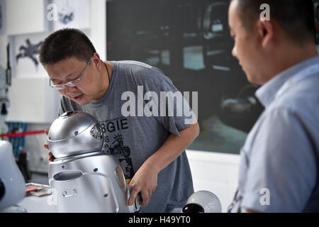 Shenzhen, China Guangdong Provinz. 14. Oktober 2016. Ein Besucher spricht mit einer Ausbildung und Roboter in der Haupt-Veranstaltungsort der nationalen Messe Innovation und Entrepreneurship Week in Shenzhen, Guangdong Provinz Süd-China, 14. Oktober 2016 zu begleiten. © Mao Siqian/Xinhua/Alamy Live-Nachrichten Stockfoto