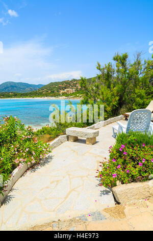 Liegestuhl am Weg zum Ferienhaus auf Insel Sardiniens - Blick von der Promenade am Strand Spiaggia del Riso, Italien Stockfoto