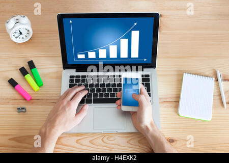Arbeiten zu Hause auf Business Pläne mit Laptop und Smartphone Stockfoto