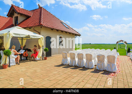 PACZULTOWICE GOLF CLUB, Polen - 9. August 2014: Orchester spielt Musik und bereitet sich auf Jäten Zeremonie in einem Golfclub mit weißen Stühlen Setup, Polen. Stockfoto