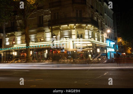 PARIS, Frankreich 13. August 2016: ein Blick auf eine Straße in Paris bei Nacht zeigt die Bewegungsunschärfe von Menschen und Restaurants, Cafés und andere Geschäfte Stockfoto