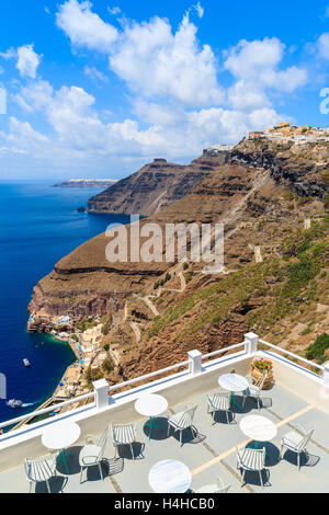 Stühle und Tische auf der Terrasse mit Blick aufs Meer im schönen Dorf Firostefani, Santorin, Griechenland Stockfoto