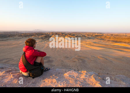 Touristen, die gerade der atemberaubenden Aussicht auf unfruchtbaren Tal, bekannt als "Mondlandschaft", Namib-Wüste, unter den wichtigsten Reise-de Stockfoto