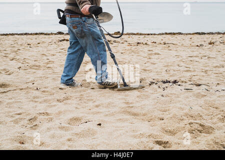 Ein Mann mit einem Metalldetektor arbeiten an Falmouth Gyllyngvase Strand Stockfoto