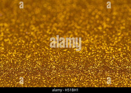 Horizontale glitzerndes Gold farbigen Hintergrundtextur mit verschwommenen Schärfentiefe Stockfoto
