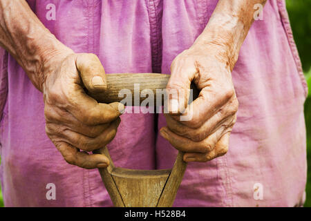 Eine Frau mit einer Schaufel auf einem Bauernhof. Stockfoto