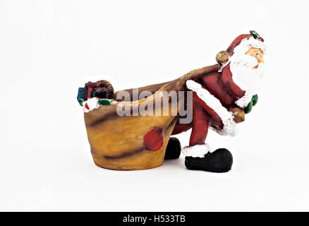 Keramik Figur des Weihnachtsmannes einen großen Sack isoliert. Stockfoto