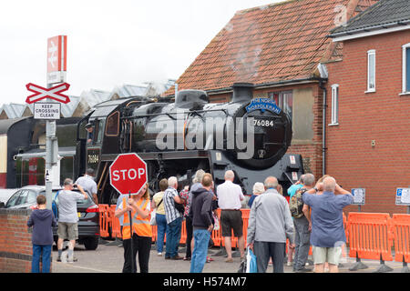 Eisenbahn-Enthusiasten watching The North Norfolkman Dampfzug nähert sich Sheringham Bahnhof, Norfolk, England Stockfoto