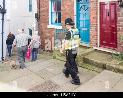 Männlicher Polizist und weibliche Polizei unterstützen Gemeinschaft Offizier in Dorfstraße in England. UK Stockfoto