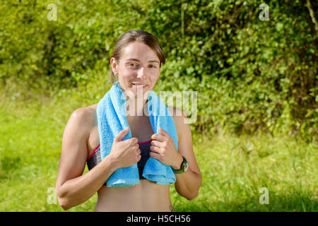 Portrait von junge sportliche Frau mit blauem Tuch auf dem Lande Stockfoto