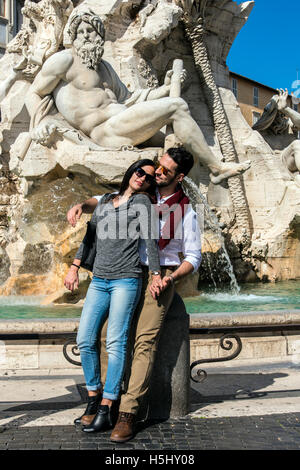 Touristischen paar Umarmung vor Brunnen der vier Flüsse in Piazza Navona, Rom, Latium, Italien Stockfoto