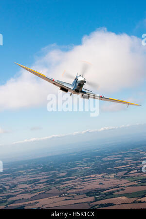 Ein Mk IX Supermarine Spitfire in RAF Lackierung frontal in einen sonnigen Spätsommer-Himmel über der englischen Landschaft. Stockfoto