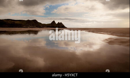 Reflections of Three Cliffs Bay Stockfoto