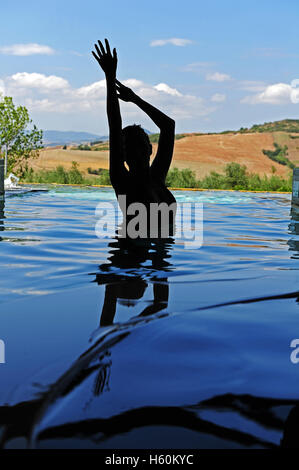 Die Silhouette einer Frau in den thermal-Innenpool von Fonteverde Natural Spa Resort in San Casciano dei Bagni, in der Nähe von Siena. Stockfoto